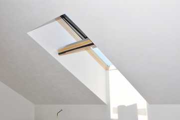 Attic house skylight window after room repair and renovation with painting and plastering wall.