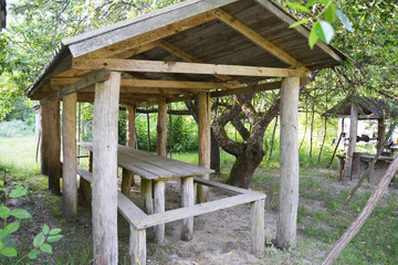 Fototapeta premium Beautiful alcove, wooden arbor, pavilion, bower, summer house, garden house in the rural garden.