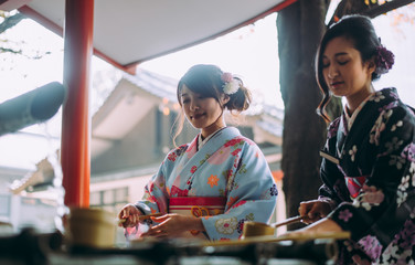 Two japanese girls wearing kimonos traditional clothes, lifestyle moments