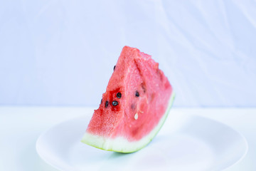 piece of watermelon on a white plate