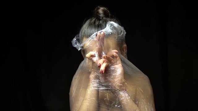Naked brunette woman breaks out of the package