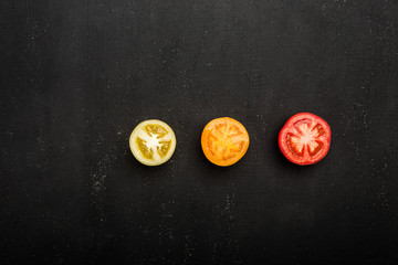 Sliced tomato as a healthy and nutritious dietary supplement on stone old background. Top view with copy space