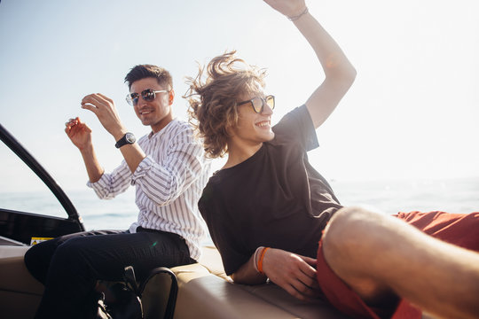 Male Tourists have sea excursion on motorboat to Murano. Hotel they stay offers to his customers possibility to integrate services and activity like fishing and tourism. Vacation, holiday, concept.
