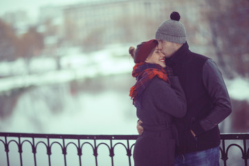 Fototapeta premium young man and woman hugging kissing outside