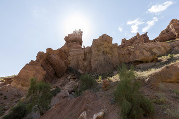 Fototapeta na wymiar Views within the Charyn Canyon to the reddish sandstone cliffs. The canyon is also called valley of castles and is located east of Almaty in Kazakhstan.