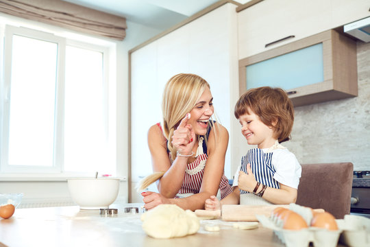 Mother And Son Bake Cakes In The Kitchen.