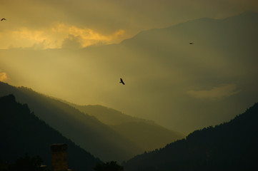 clouds with sunbeams. silhouettes of mountains and clouds at dawn