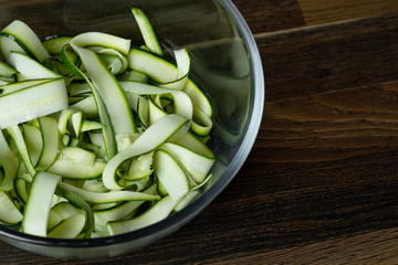Fresh zucchini slices in glass bowl for cooking vegetables diet salad. Healthy food concept