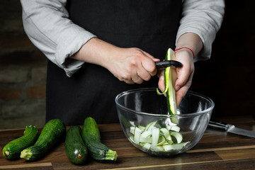 Cooking fresh zucchini slices in glass bowl for cooking vegetables diet salad. Healthy food concept