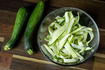 Fresh zucchini slices in glass bowl for cooking vegetables diet salad. Healthy food concept