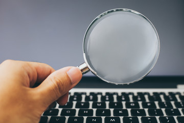 Magnifying Glass With Laptop Background