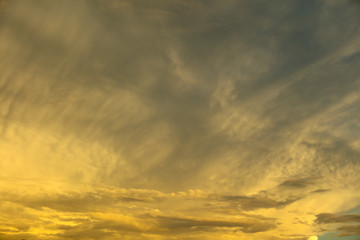 Clouds in the rays of sunset as background