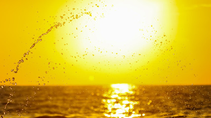 Splashing water at sunset as an abstract background