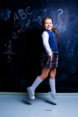   girl   at school against chalkboard