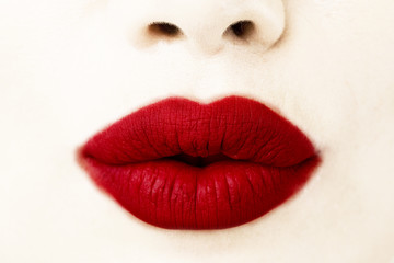 Woman's lips with lipstick and kiss close up view