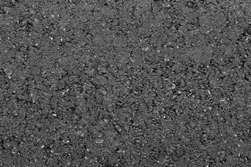 Texture of fresh hot asphalt. Black background resembling anthracite.