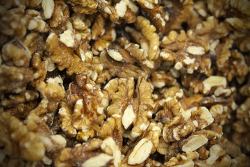 Closeup of a large shelled heap of walnuts, food background.