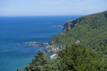 Summer sea, San Juan Gaztelugatxe island view, basque country, historical island with chapel in Northern Spain