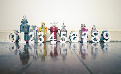 counting retro robots 0 to 9 on a wooden floor