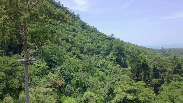 Aerial View of Tourists Riding on Zipline or Canopy Rope. Adrenaline Adventure on Vacation