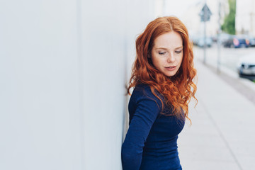 Thoughtful sad young woman with downcast eyes