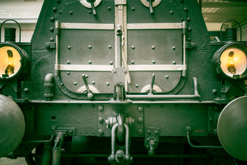 Old mechanism toned photo.  Retro style machinery, gear, metal cogwheels, nuts and bolts.