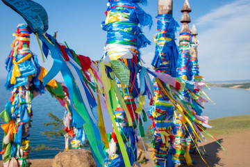 Prayer ribbons of sacred Serge pillars on Olkhon island