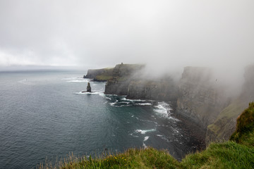 Fototapeta na wymiar The Cliffs of Moher with fog arising from the ocean