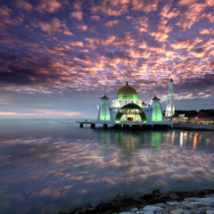 Glowing Strait Mosque of Malacca during sunset with dramatic sky. The so called swimming Mosque is...