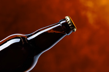 Closed  bottle of beer on a dark background.