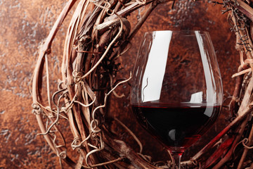 Dried vine and  glass of red wine.