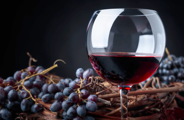 Glass of red wine and grapes.