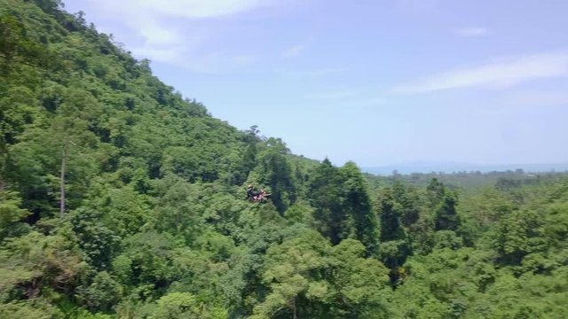 Aerial View of Tourists Riding on Zipline or Canopy Rope. Adrenaline Adventure on Vacation