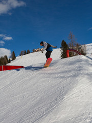 Snowboarder in Action: Jumping in the Mountain Snowpark