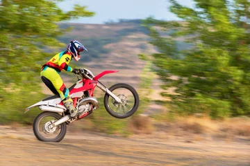 Zelfklevend Fotobehang Motocross rider doing a wheelie © herraez
