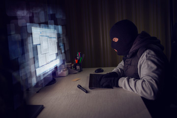Computer hacker stealing data from a computer