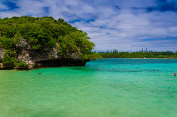 Obraz premium Empty abandoned quiet island with sea green bule water and cloudy sky with forest rock and trees for vacation holiday destination for cruise ship