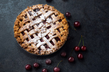 homemade cherry pie with a flaky crust and powdered sugar.