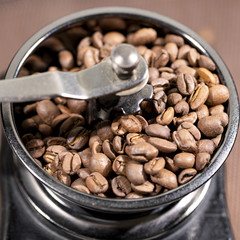 The fried coffee beans lie in a coffee grinder. Arab coffee is prayed in a mechanical coffee grinder. Morning coffee.