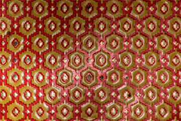 Metallic texture of red and yellow hexagons. Pattern. Retro look, old and shiny.