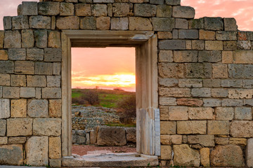 architectural element of ancient Chersonese at sunset near the Black Sea, beautiful ruins on red sky background