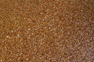 Large sea sand: precise and detailed texture. A fine accurate detailed texture of wet large sand. Beach sand close-up for background. Can be used in the production of video games or printed products.