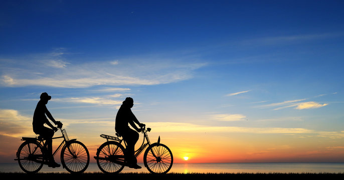 Silhouette group bike relaxing on sunrise