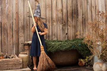 Young witch flew on broom in secluded place to plunge into cauldron with decoction of rejuvenating...