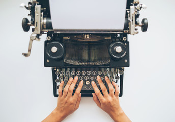 Writer typing with retro typewriter, high angle view