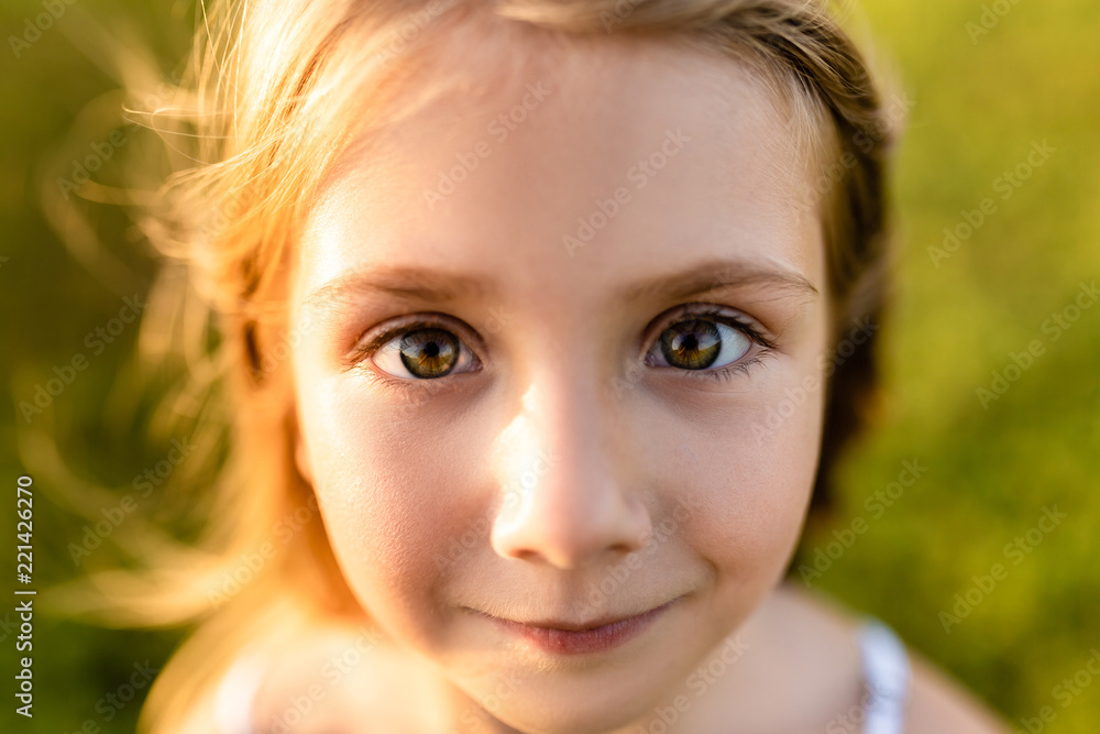 Wall mural close-up portrait of adorable little child looking at camera