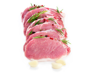 Pork steak, raw carbonate fillet isolated on white background, meat with rosemary, garlic seasonings, side view