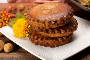 Round Dutch homemade cookies filled with marzipan and almonds nuts, autumn and winter seasonal dessert in Netherlands
