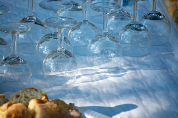 Table served outside in garden with many empty wine glasses for party, celebration or wine tasting