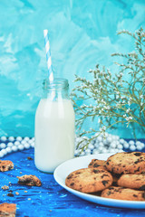 Cookie chocolate with a organic milk bottles near flower